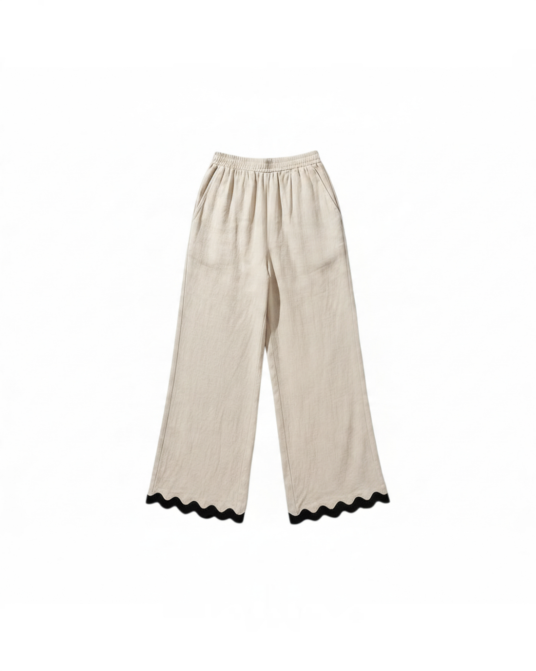 Pantalones wide-leg beige de Yanet Collective con cintura elástica y detalle de ribete negro ondulado en el bajo